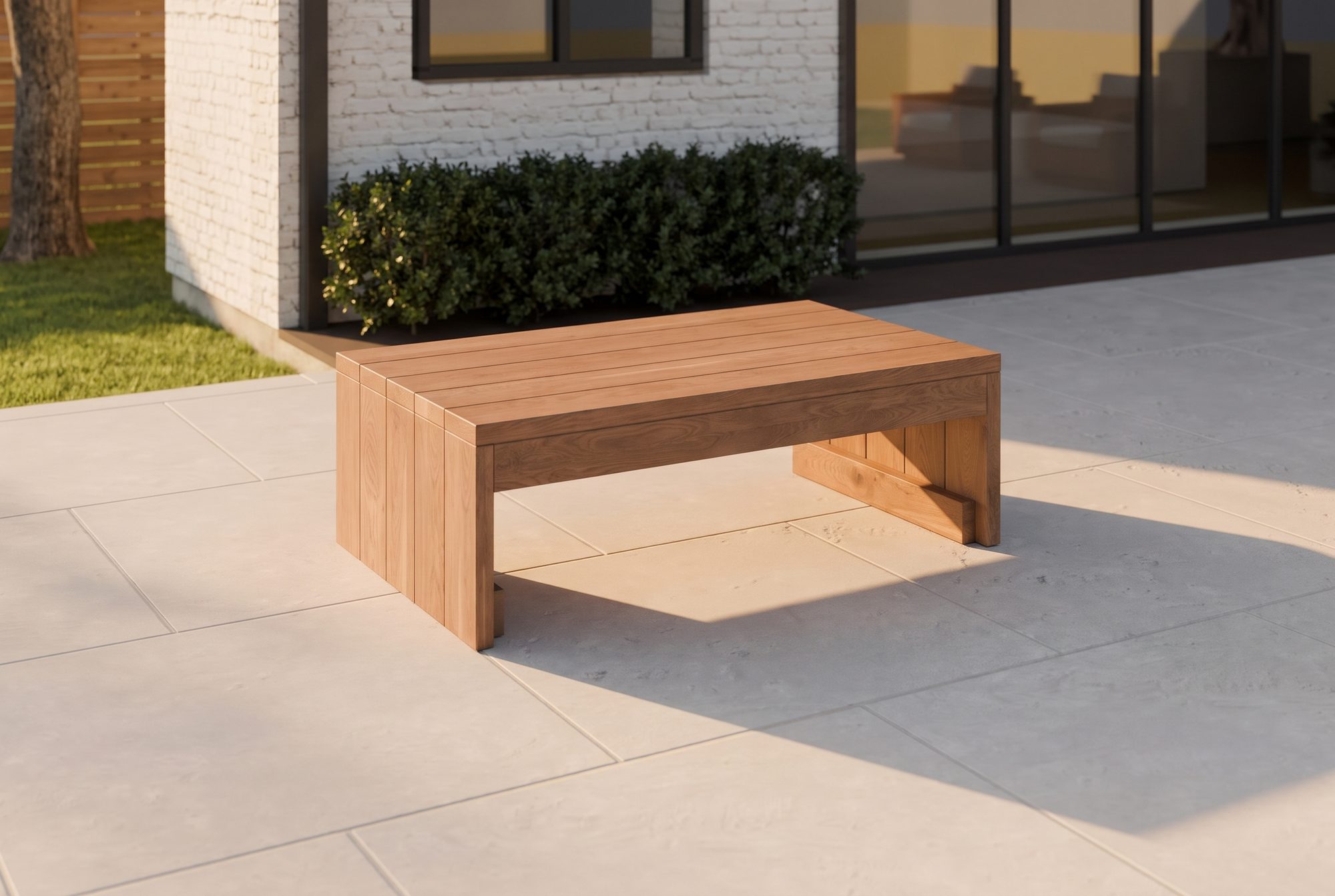 The Block Coffee Table in honey-oiled cedar on a backyard patio