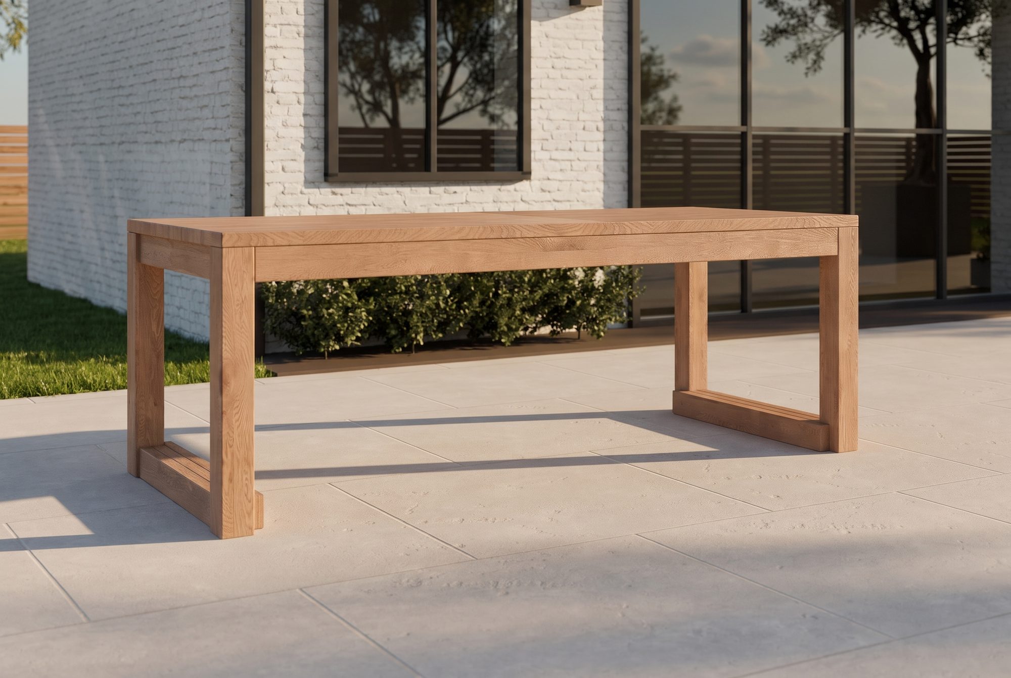 The Block Dining Table in honey-oiled cedar on a backyard patio